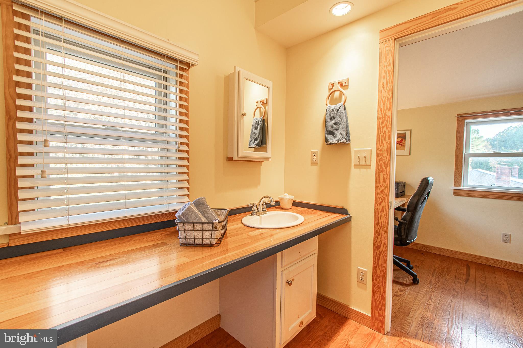 8805 Cummings Road Wittman, MD 21676 - Photo 24 of 39 a bathroom with a sink a mirror and a window