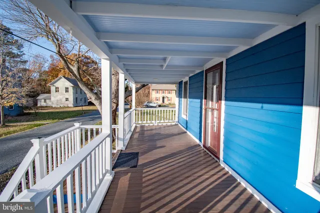 a view of a balcony with furniture and wooden deck