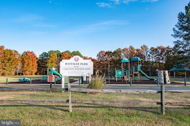 a view of a balcony with chairs and wooden floor