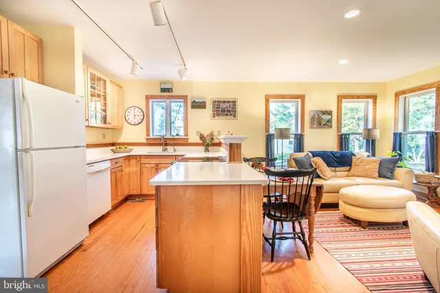 a kitchen with a table chairs refrigerator and cabinets