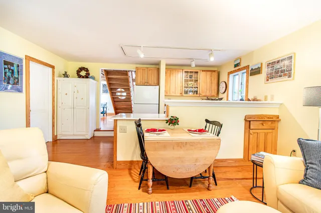 a living room with furniture a flat screen tv and a table
