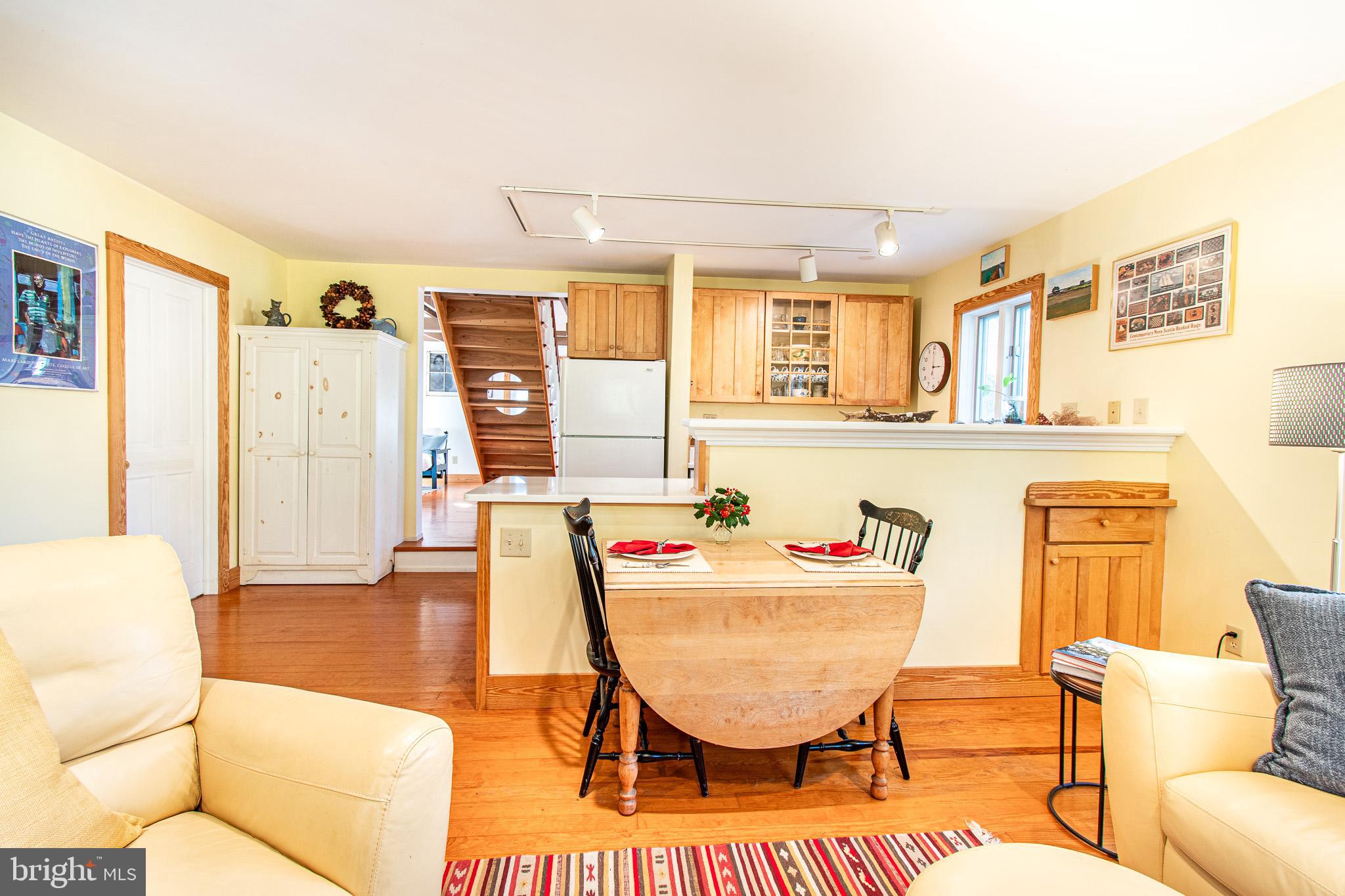 8805 Cummings Road Wittman, MD 21676 - Photo 7 of 39 a living room with furniture a flat screen tv and a table