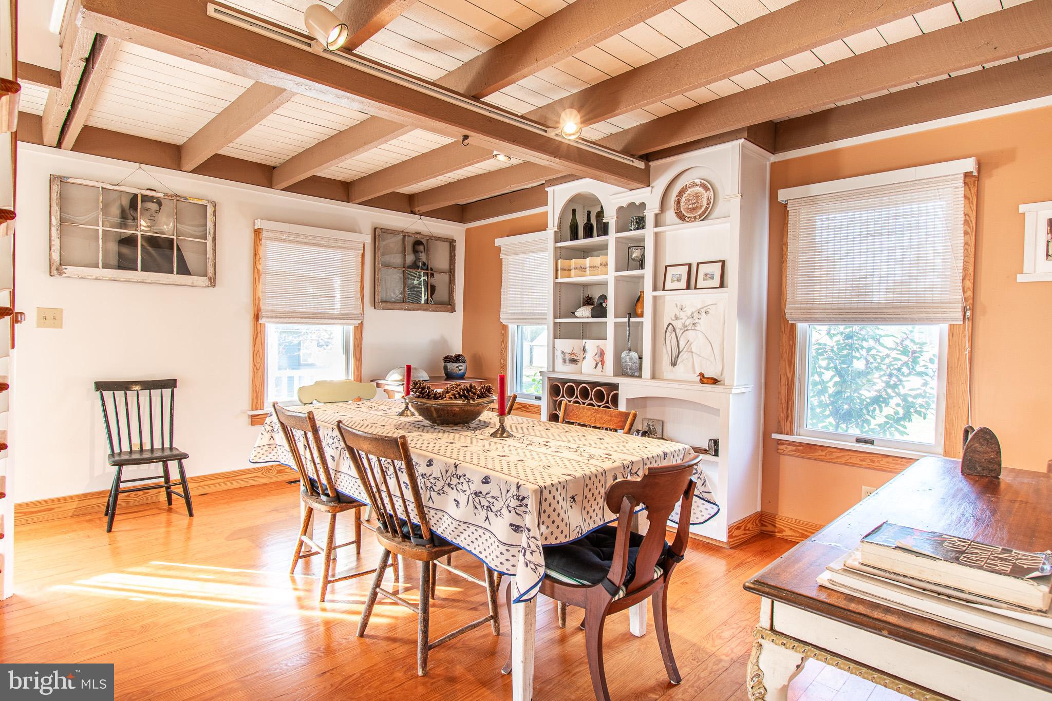 8805 Cummings Road Wittman, MD 21676 - Photo 9 of 39 a view of a dining room with furniture window and wooden floor
