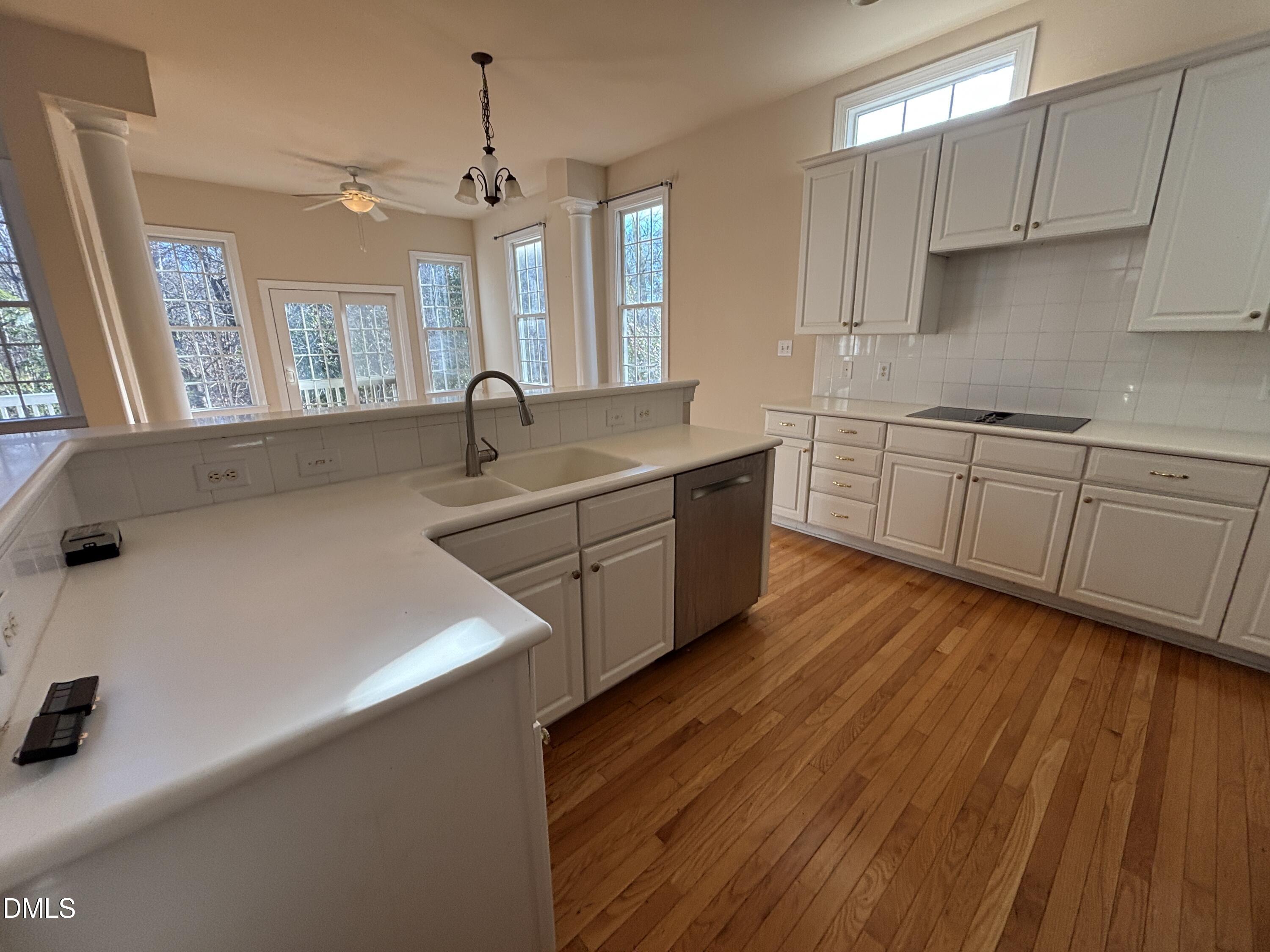 11729 Broadfield Court Raleigh, NC 27617 - Photo 12 of 47 a kitchen with stainless steel appliances sink a stove and white cabinets