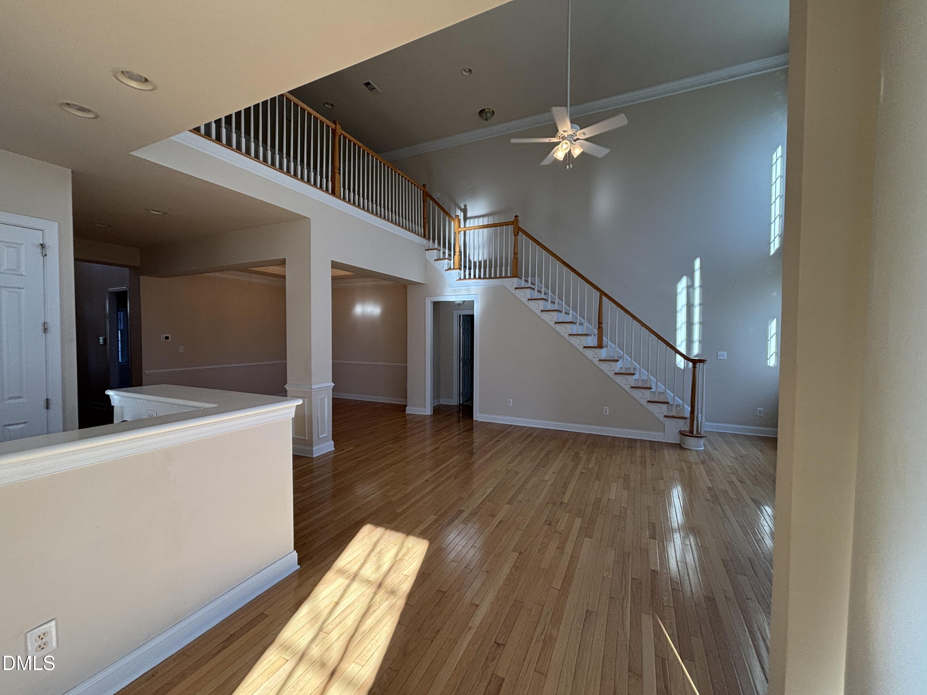 11729 Broadfield Court Raleigh, NC 27617 - Photo 18 of 47 a view of a room with wooden floor and staircase