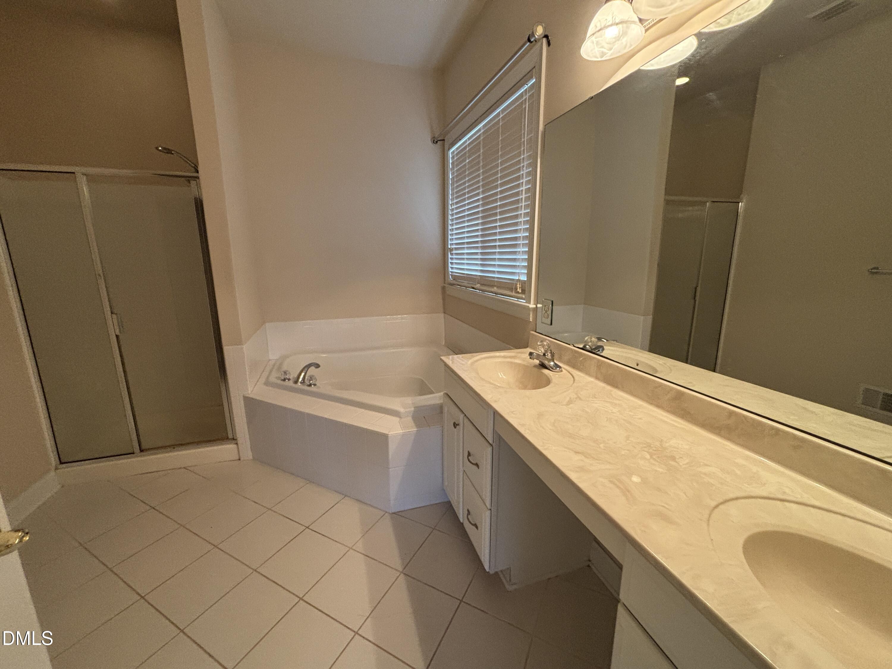 11729 Broadfield Court Raleigh, NC 27617 - Photo 21 of 47 a bathroom with a granite countertop sink and a mirror