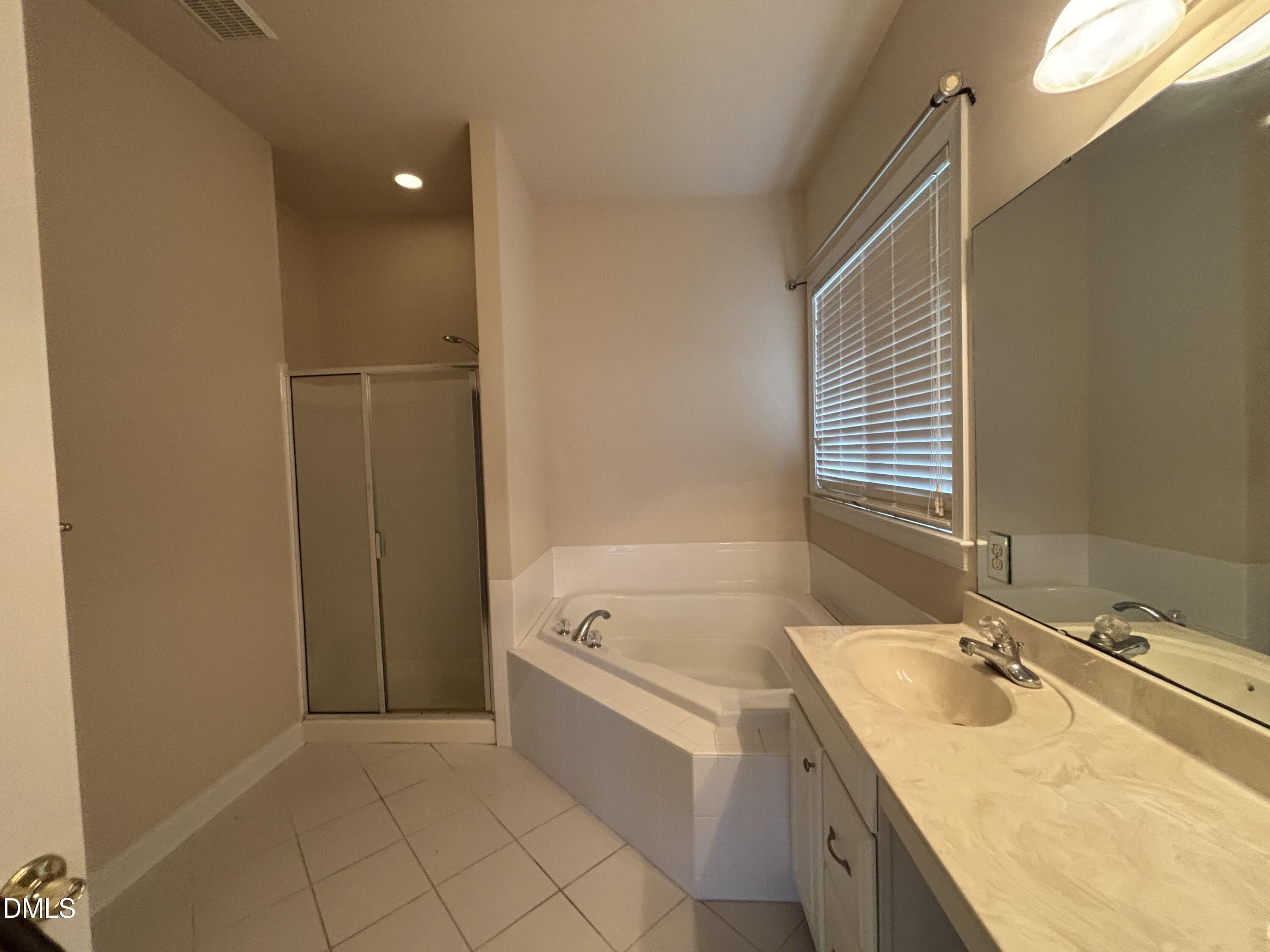 11729 Broadfield Court Raleigh, NC 27617 - Photo 22 of 47 a spacious bathroom with a tub sink and mirror