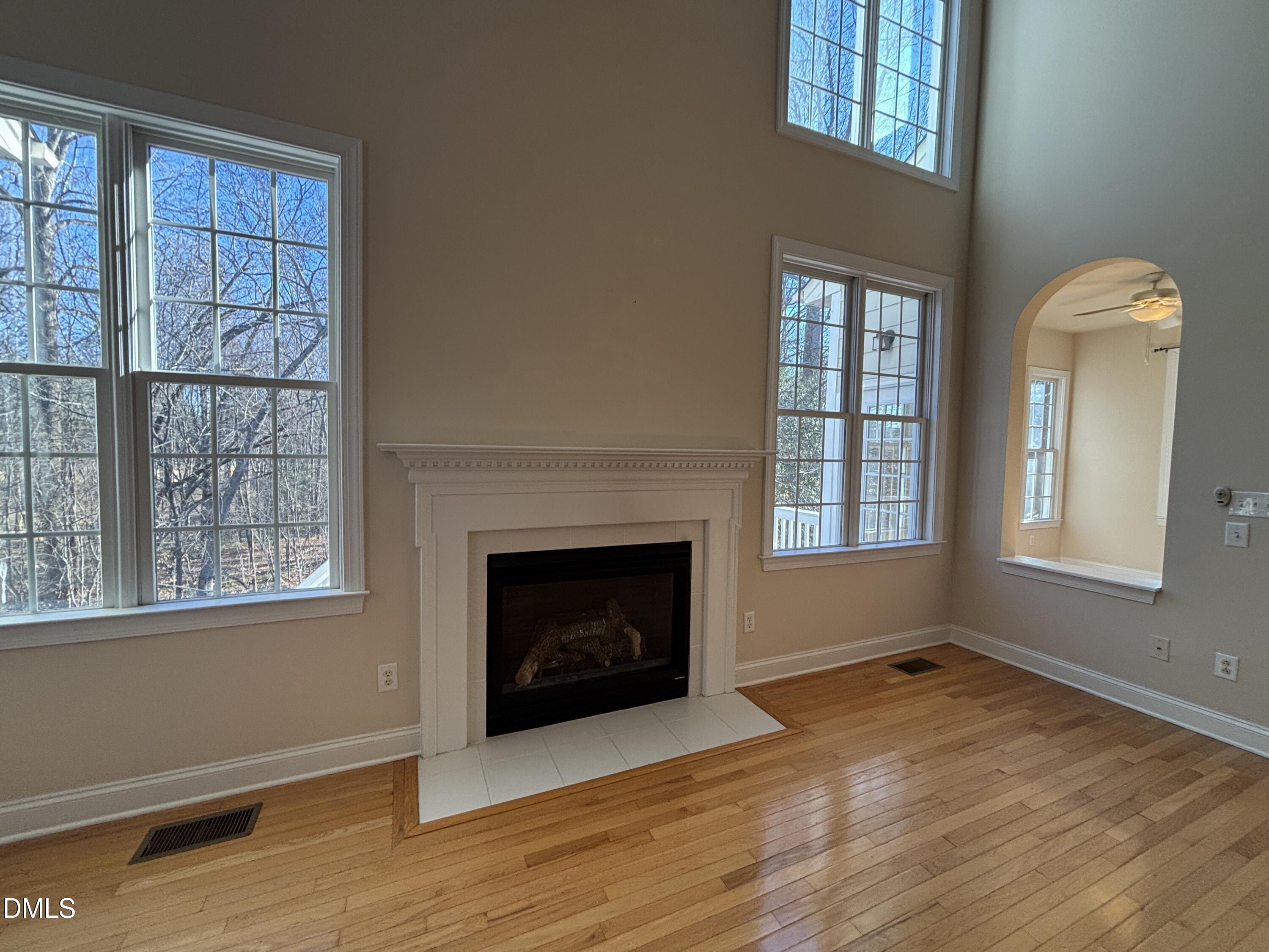 11729 Broadfield Court Raleigh, NC 27617 - Photo 24 of 47 a view of an empty room with windows and a fireplace
