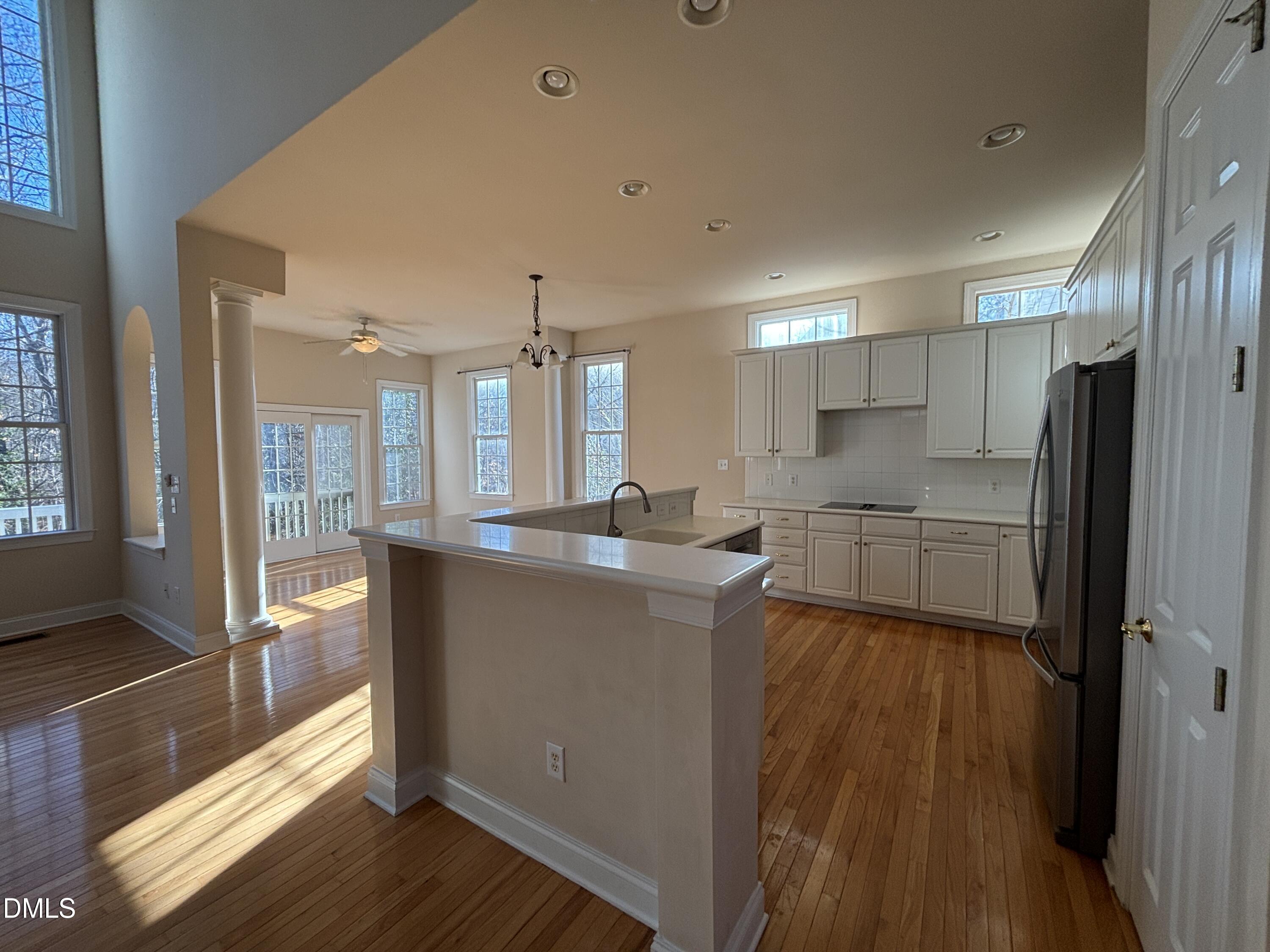 11729 Broadfield Court Raleigh, NC 27617 - Photo 3 of 47 a kitchen with stainless steel appliances granite countertop a refrigerator a sink dishwasher a stove and white countertops with wooden floor