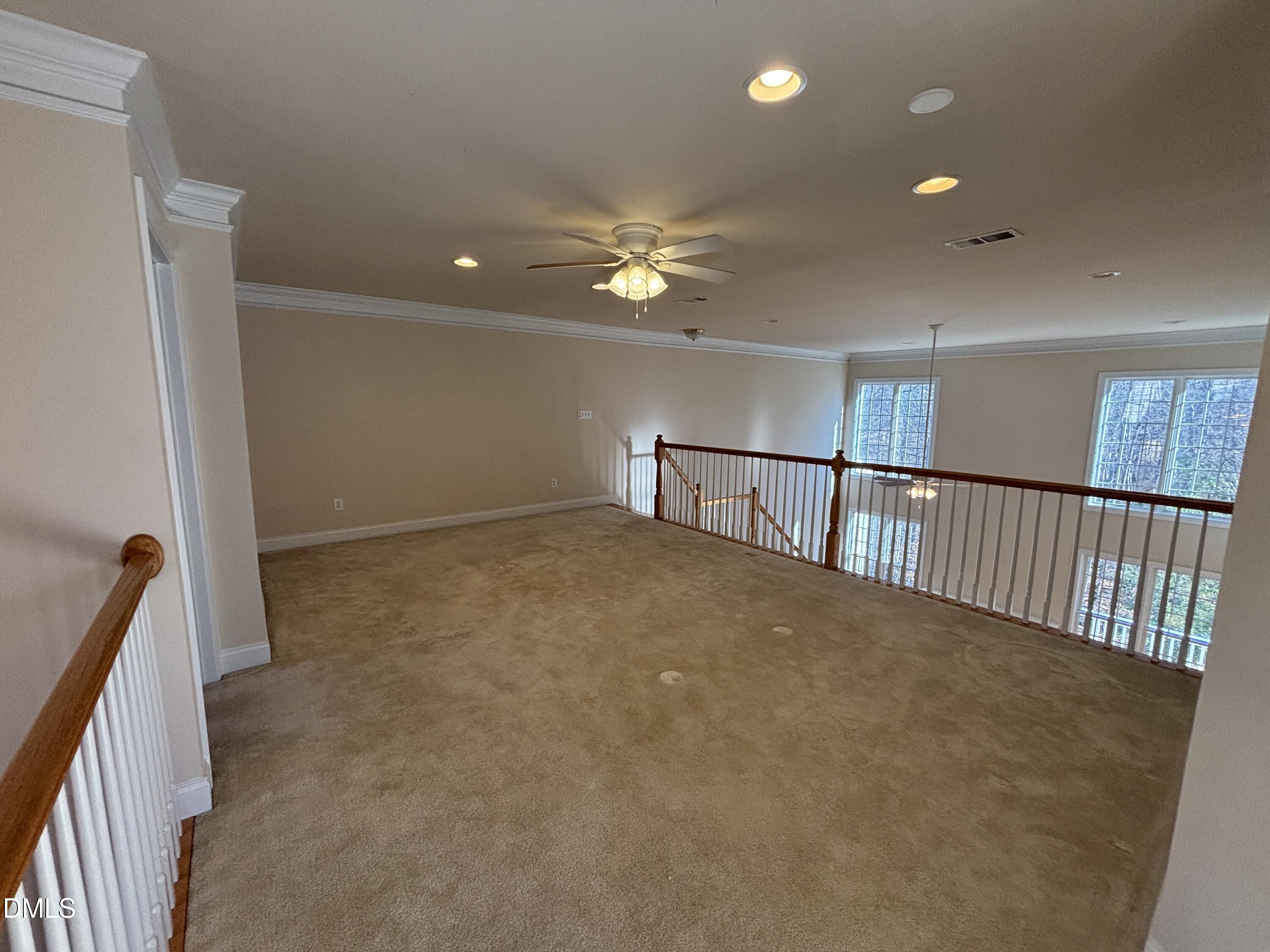 11729 Broadfield Court Raleigh, NC 27617 - Photo 35 of 47 a view of a hallway with a ceiling fan