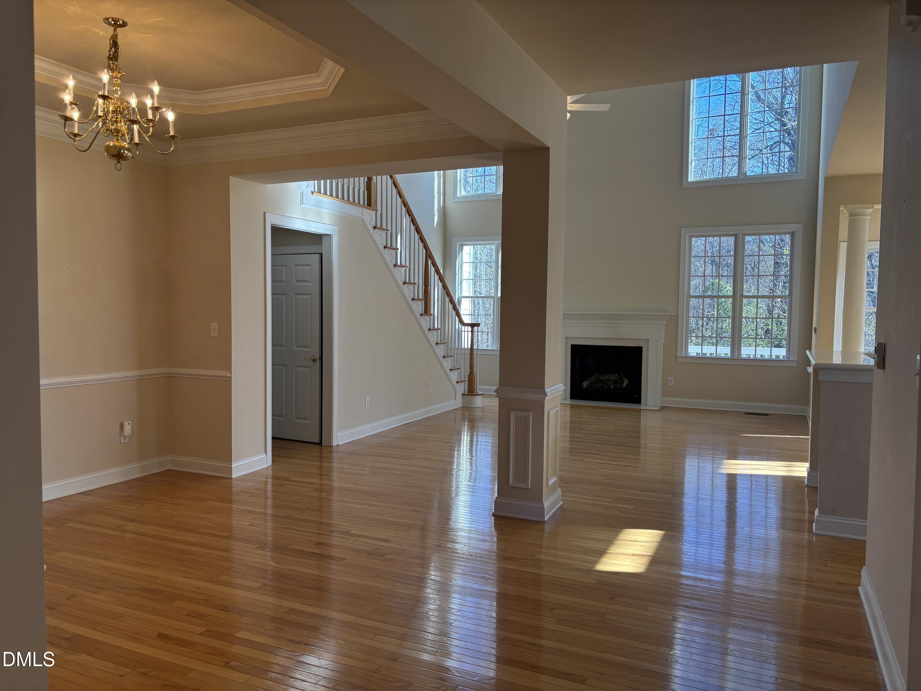 11729 Broadfield Court Raleigh, NC 27617 - Photo 7 of 47 a view of a livingroom with wooden floor and staircase