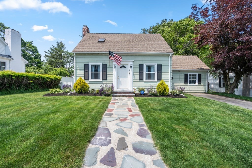 a front view of a house with garden