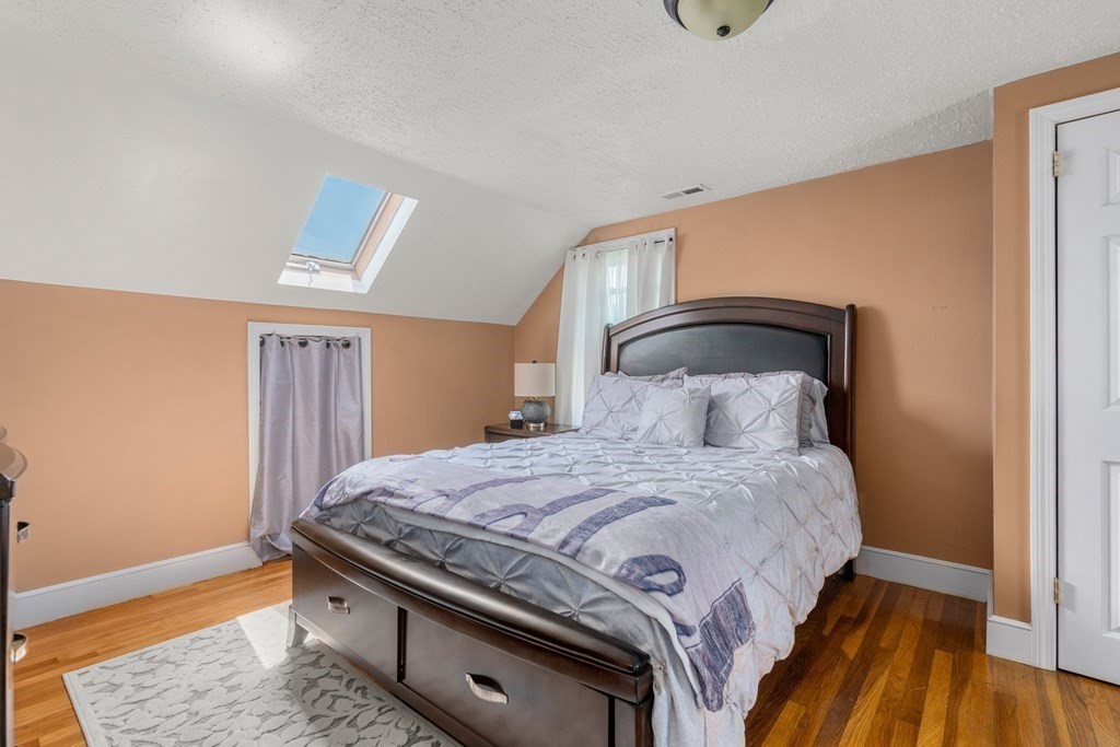 27 Upland Road Brockton, MA 02301 - Photo 13 of 25 a bedroom with a bed and wooden floor