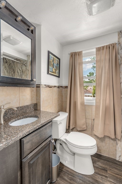27 Upland Road Brockton, MA 02301 - Photo 14 of 25 a bathroom with a granite countertop toilet sink and mirror