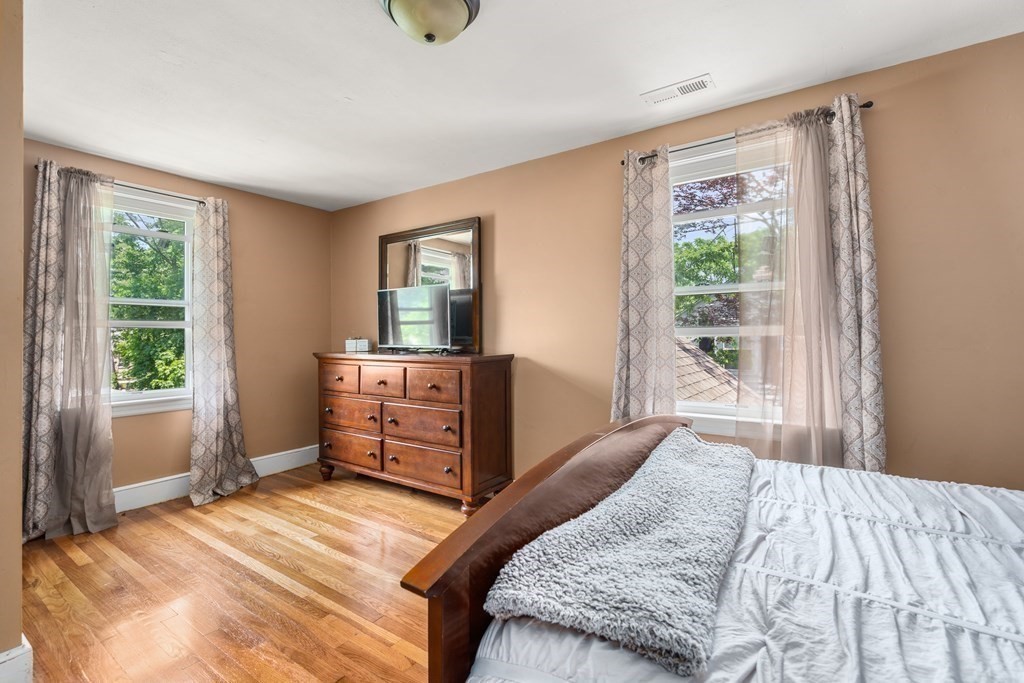 27 Upland Road Brockton, MA 02301 - Photo 15 of 25 a bedroom with a bed and wooden floor
