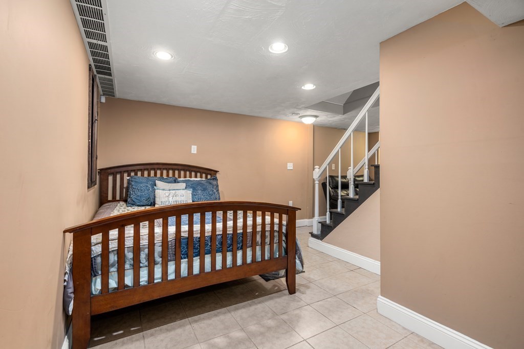 27 Upland Road Brockton, MA 02301 - Photo 19 of 25 a bedroom with furniture and stairs