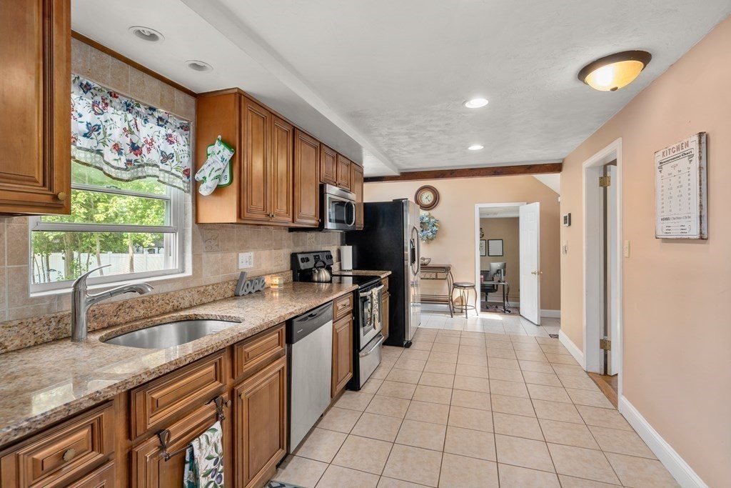 27 Upland Road Brockton, MA 02301 - Photo 7 of 25 a kitchen with stainless steel appliances granite countertop a refrigerator and sink