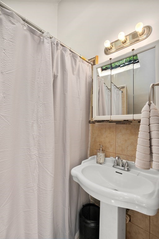 27 Upland Road Brockton, MA 02301 - Photo 10 of 25 a bathroom with a sink and a mirror