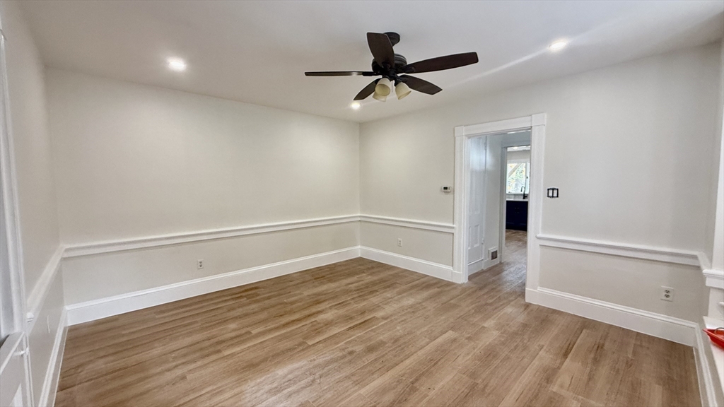 225 Pleasant Street, Unit 1 Weymouth, MA 02190 - Photo 3 of 10 a view of an empty room with wooden floor