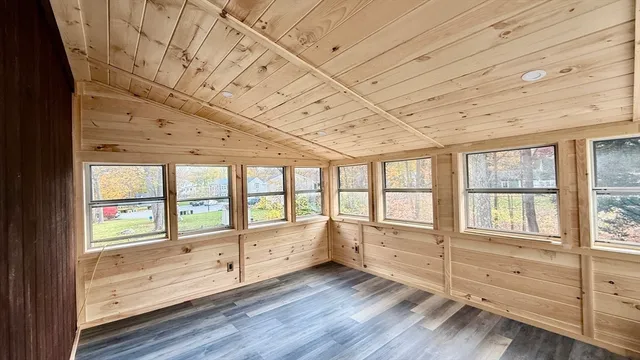 view of an empty room with wooden floor and a window