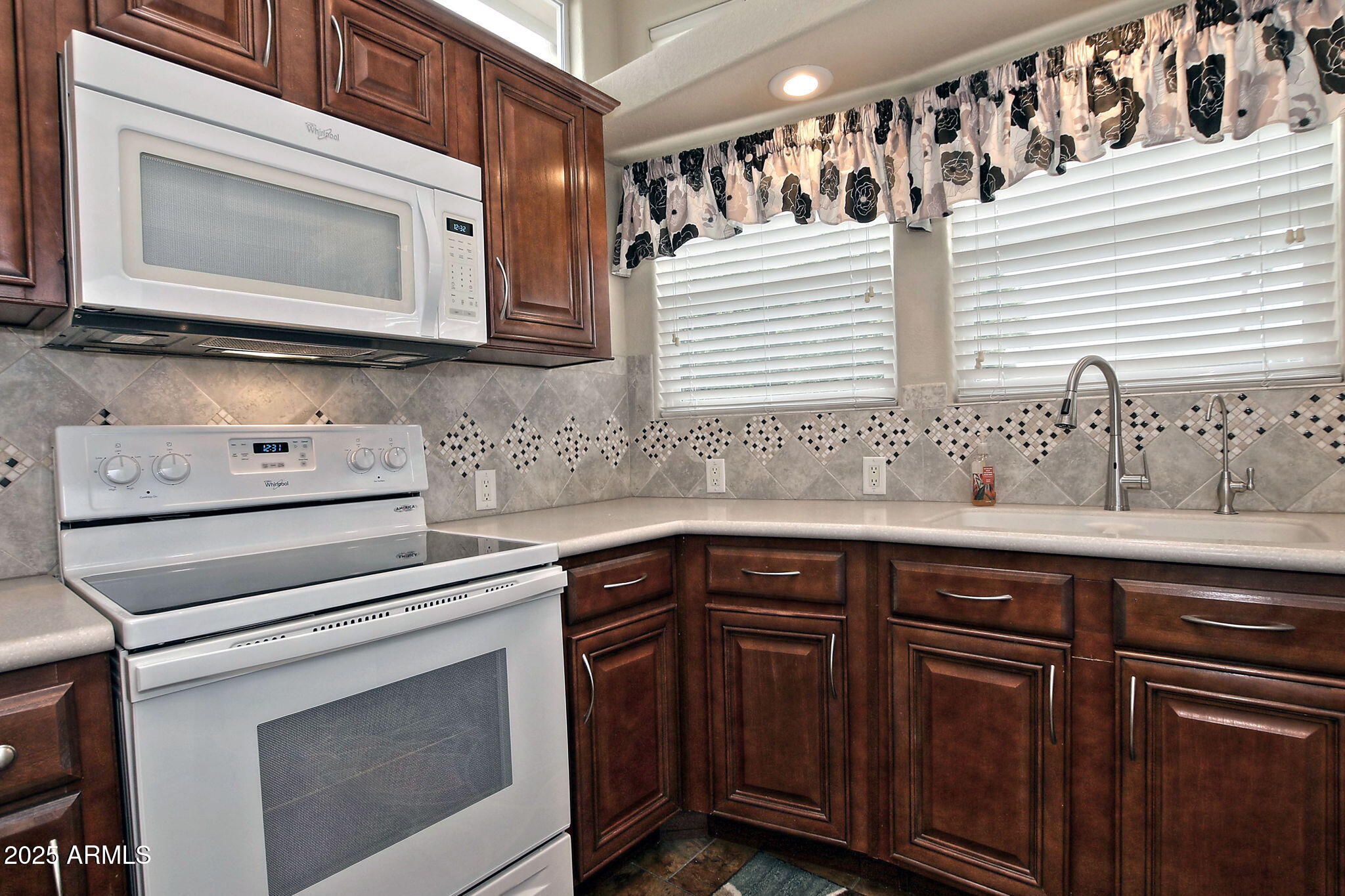111 South Greenfield Road, Unit 462 Mesa, AZ 85206 - Photo 13 of 34 a kitchen with granite countertop white cabinets and white appliances