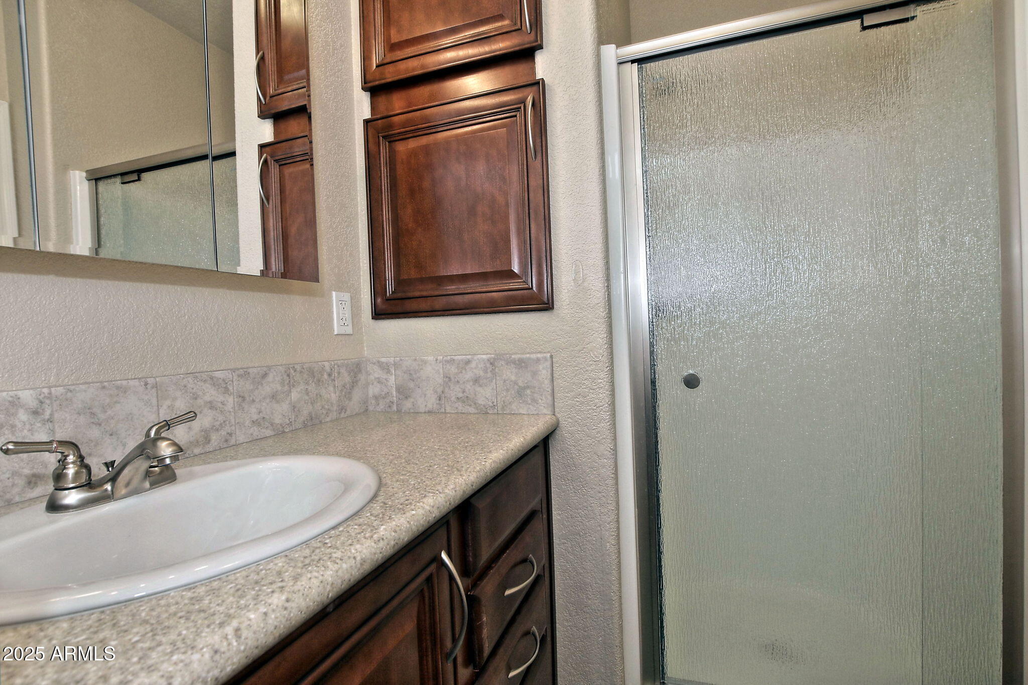111 South Greenfield Road, Unit 462 Mesa, AZ 85206 - Photo 22 of 34 a bathroom with a granite countertop sink and a mirror