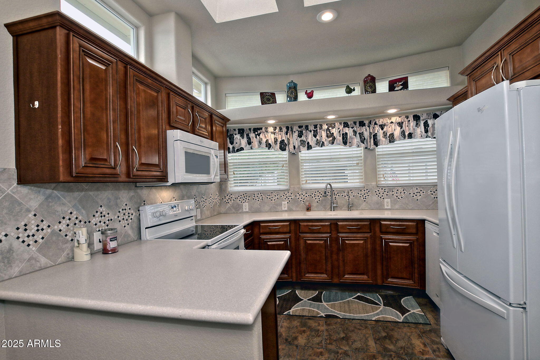 111 South Greenfield Road, Unit 462 Mesa, AZ 85206 - Photo 3 of 34 a kitchen with stainless steel appliances granite countertop a sink stove and cabinets