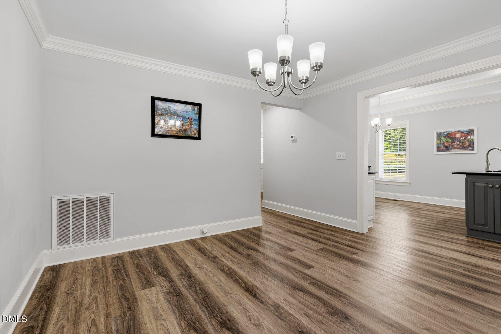 726 Thomas Road Rocky Mount, NC 27801 - Photo 11 of 55 a view of an empty room with wooden floor and a window