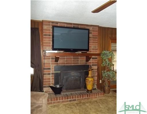 950 Old Olive Branch Road Ellabell, GA 31308 - Photo 9 of 25 Living Room. Masonary wood burning fireplace