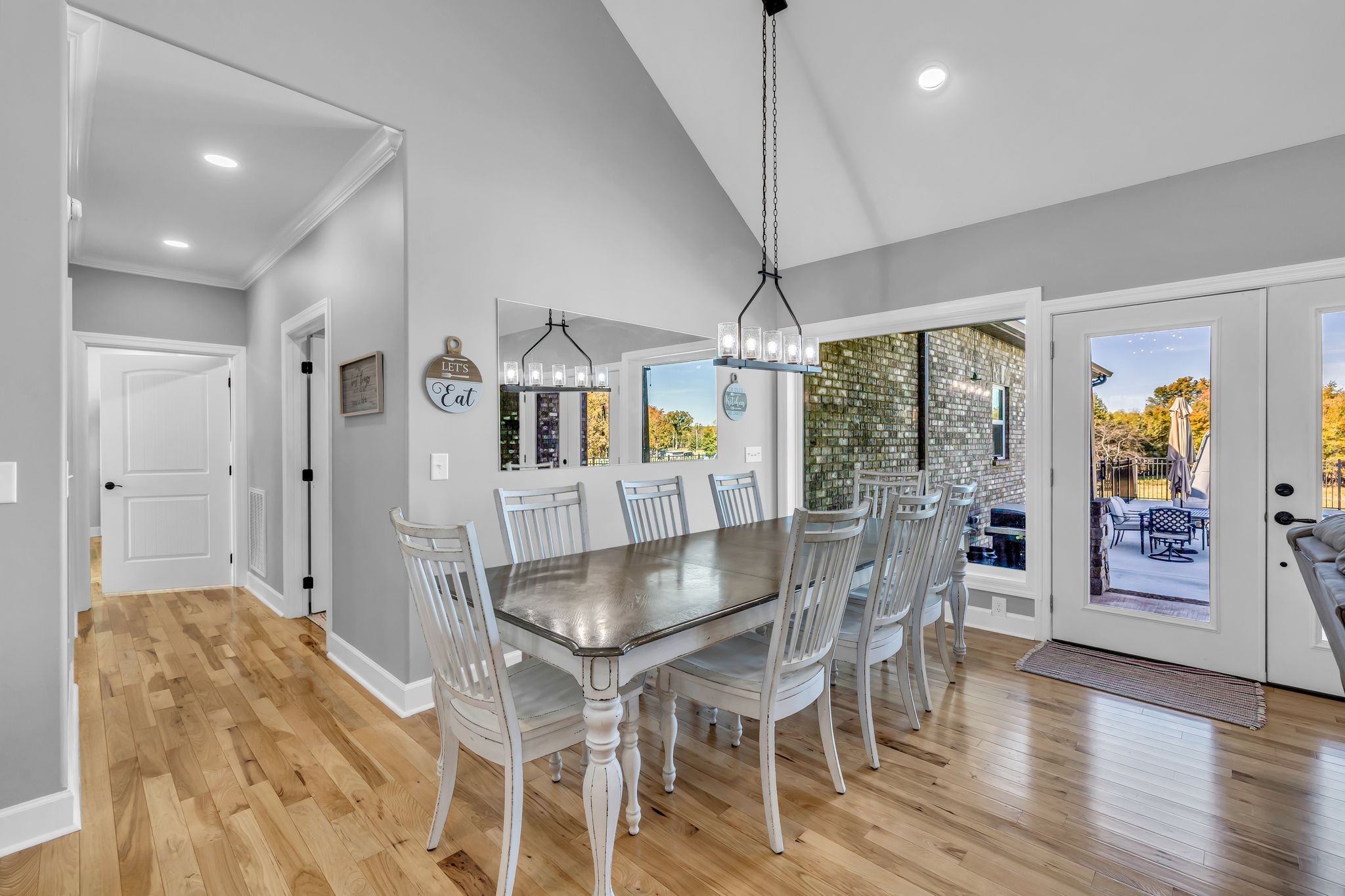 1645 Oak Grove Road Decherd, TN 37324 - Photo 11 of 46 a dining room with wooden floor a chandelier a wooden table and chairs