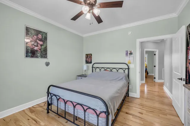 a bedroom with a bed and a chandelier