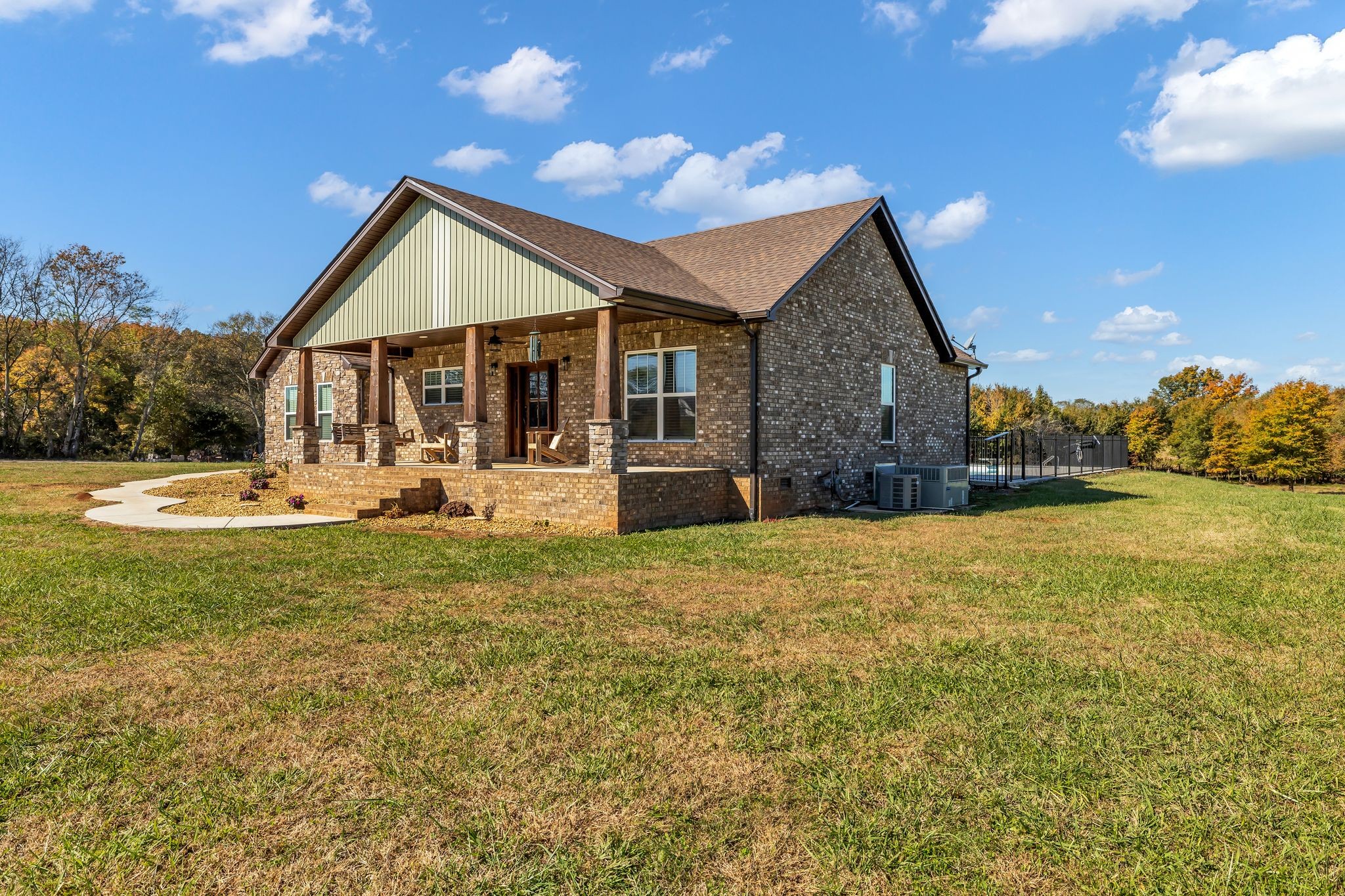 1645 Oak Grove Road Decherd, TN 37324 - Photo 4 of 46 a front view of house with yard and trees in the background