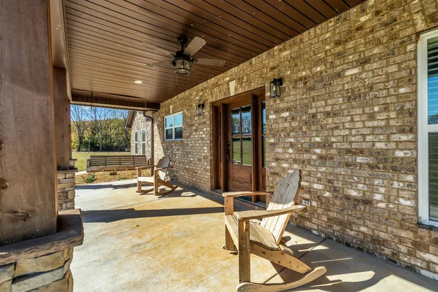 a view of a patio with table and chairs and potted plants