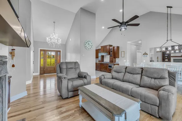 a living room with furniture and a chandelier