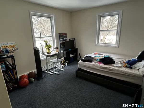a bedroom with furniture and a window