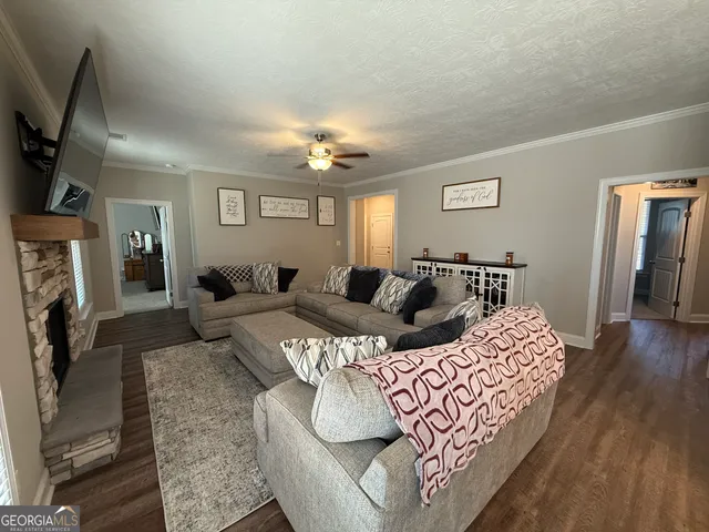a living room with furniture fireplace and flat screen tv