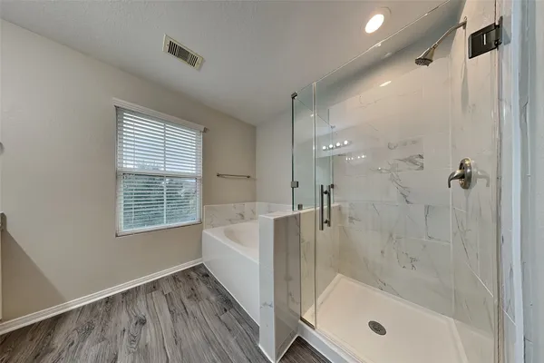 a bathroom with a bathtub and a shower