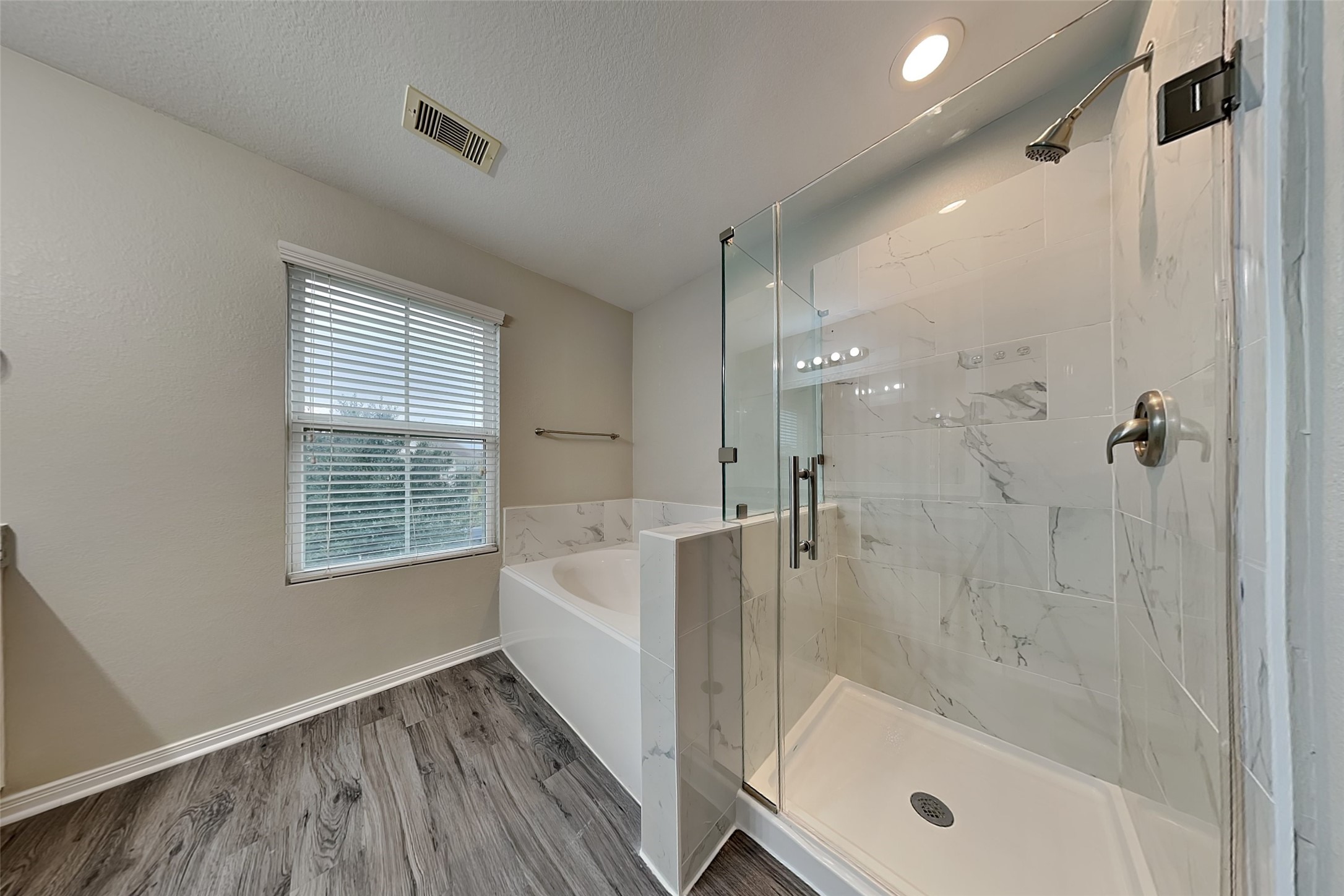 2519 Elm Crossing Trail Spring, TX 77386 - Photo 11 of 20 a bathroom with a bathtub and a shower