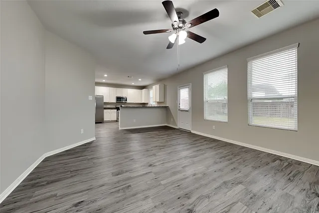 a view of a kitchen with a dishwasher cabinets and wooden floor