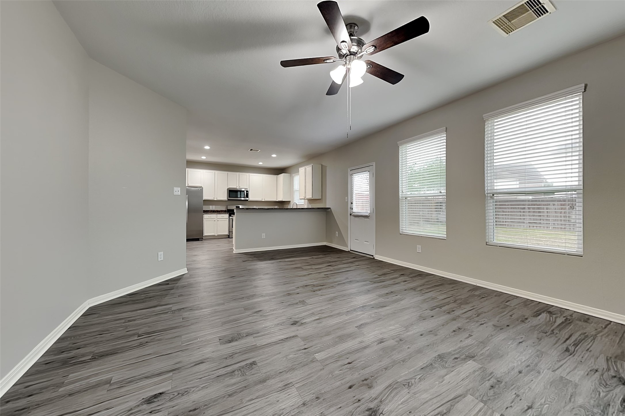 2519 Elm Crossing Trail Spring, TX 77386 - Photo 2 of 20 a view of a kitchen with a dishwasher cabinets and wooden floor