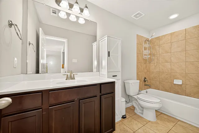 a bathroom with a sink a toilet and a large mirror