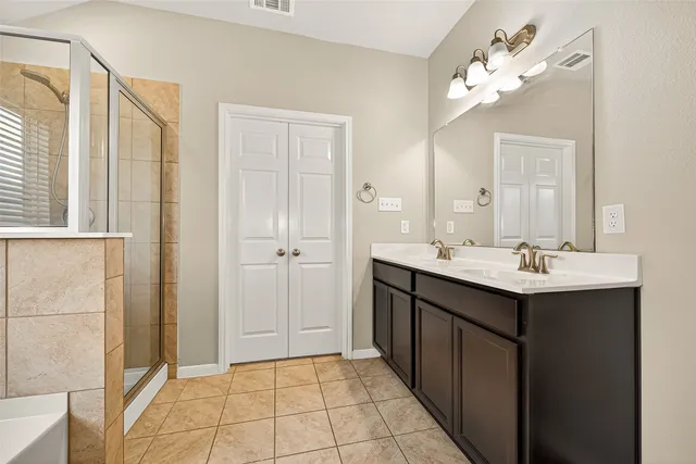 a bathroom with a sink vanity and a mirror