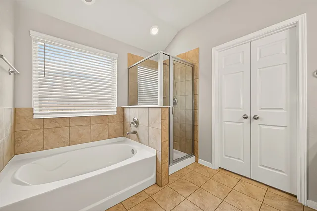 a bathroom with a bathtub and a shower