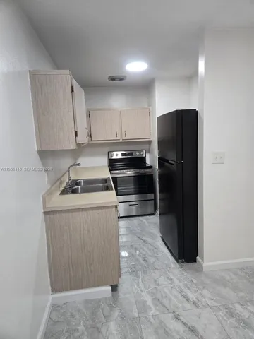 a kitchen with a refrigerator stove and cabinets