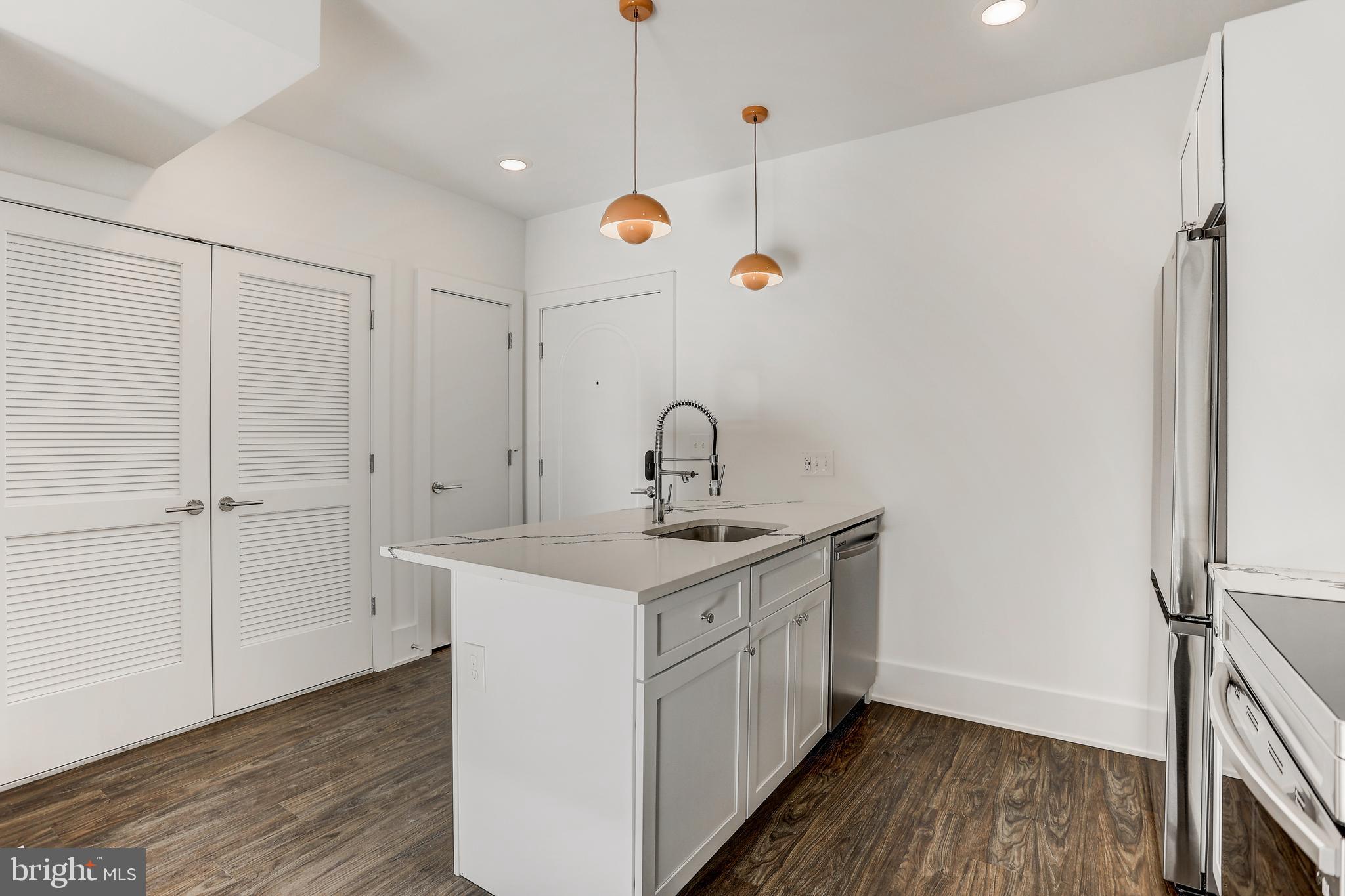 5959-63 Ridge Avenue, Unit 1BED/1BATH Philadelphia, PA 19128 - Photo 11 of 32 a bathroom with a sink a mirror and shower