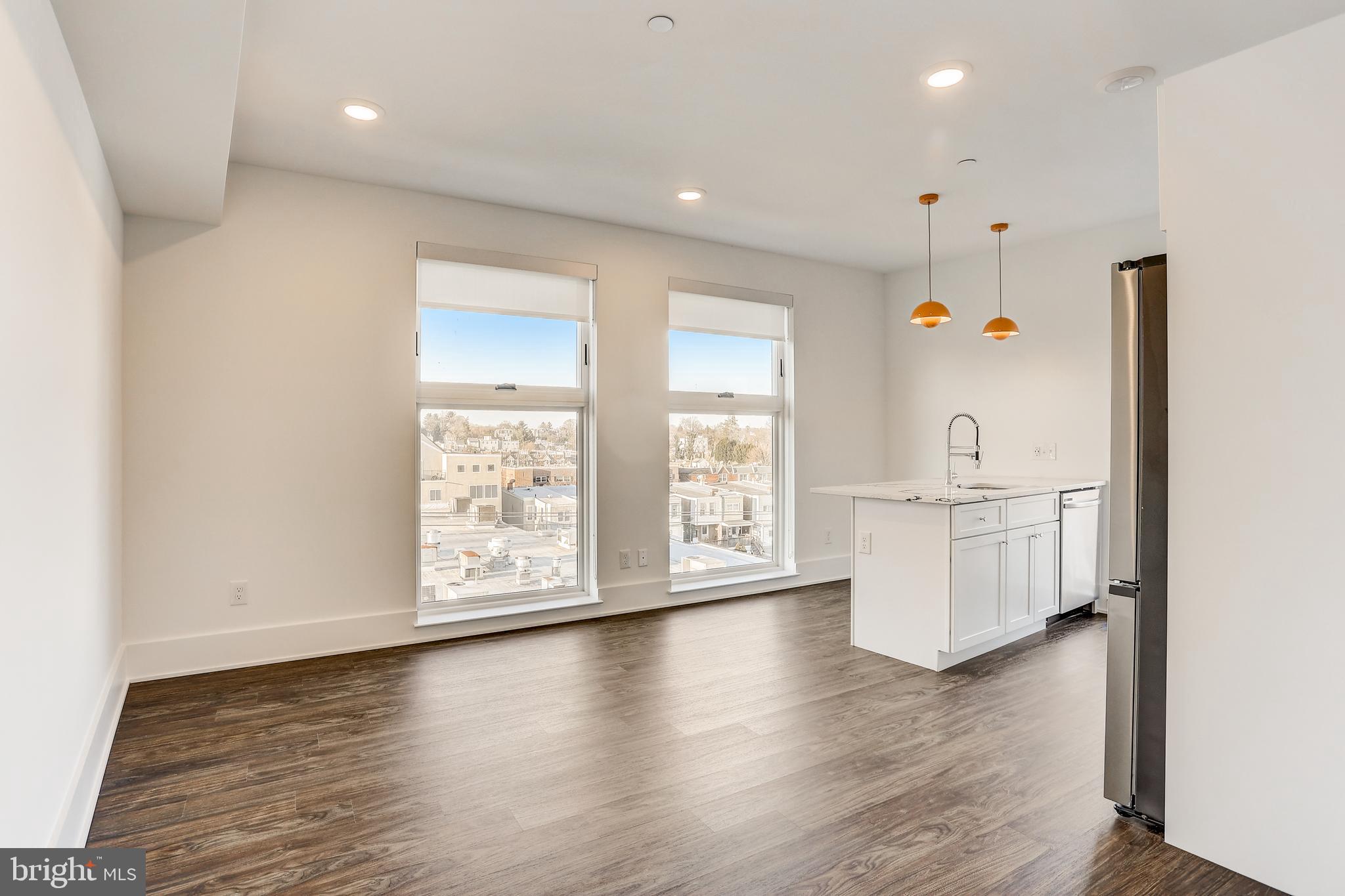 5959-63 Ridge Avenue, Unit 1BED/1BATH Philadelphia, PA 19128 - Photo 21 of 32 a view of an empty room with a window and wooden floor