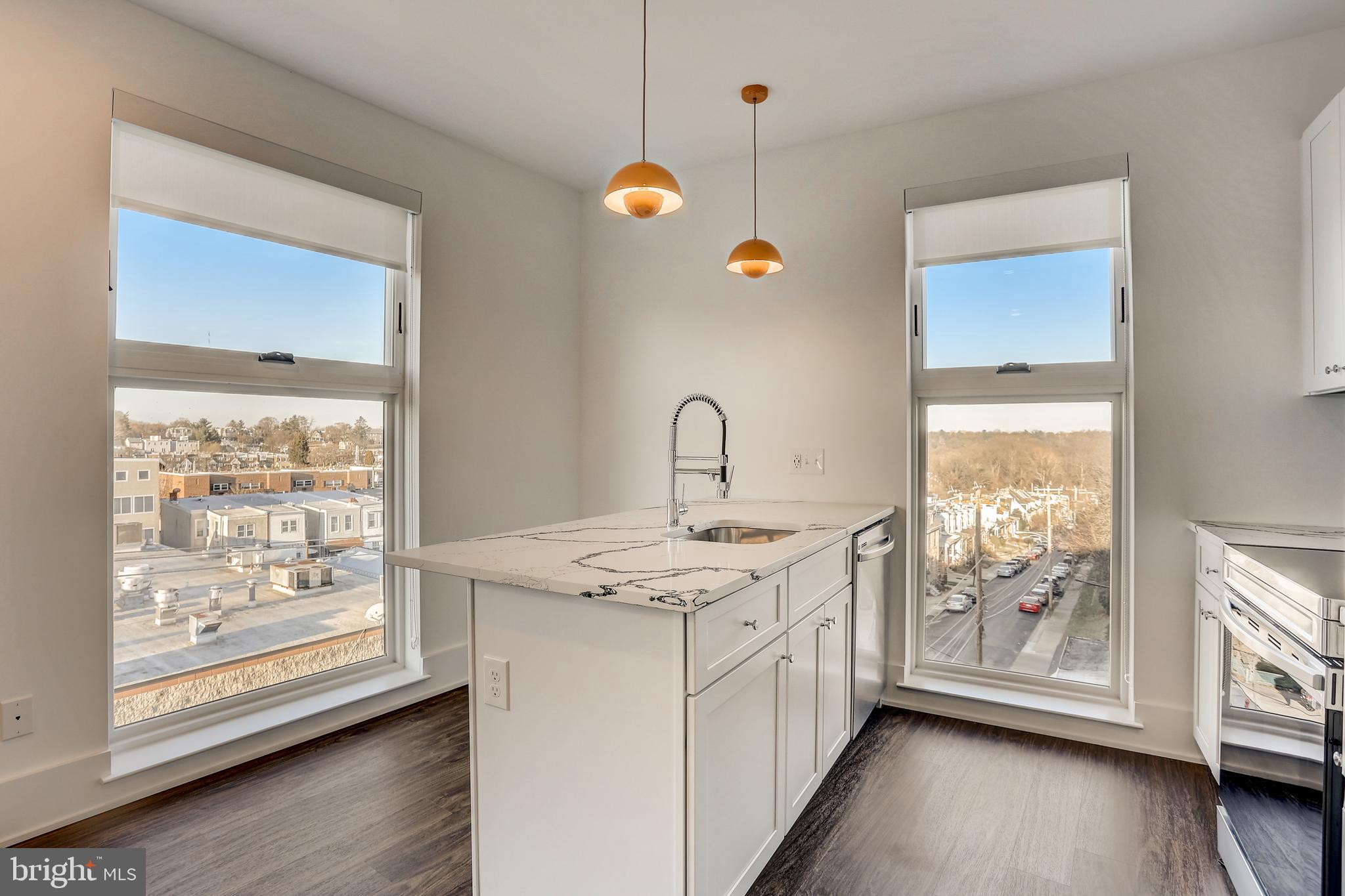 5959-63 Ridge Avenue, Unit 1BED/1BATH Philadelphia, PA 19128 - Photo 22 of 32 a kitchen with a sink window and wooden floor
