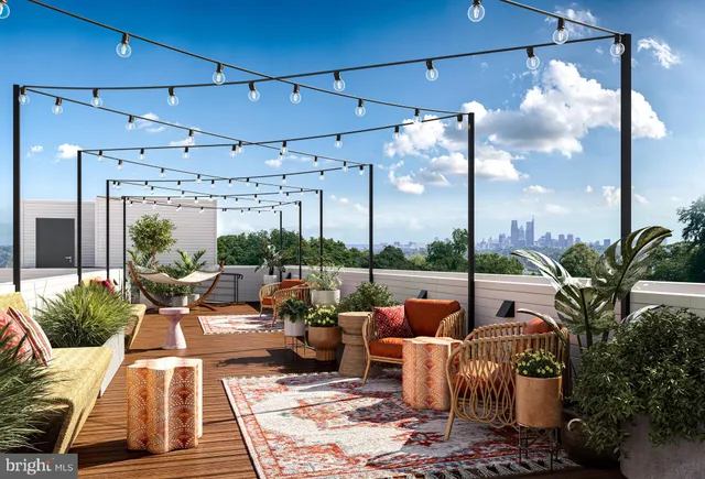 a living room with patio furniture and a potted plant