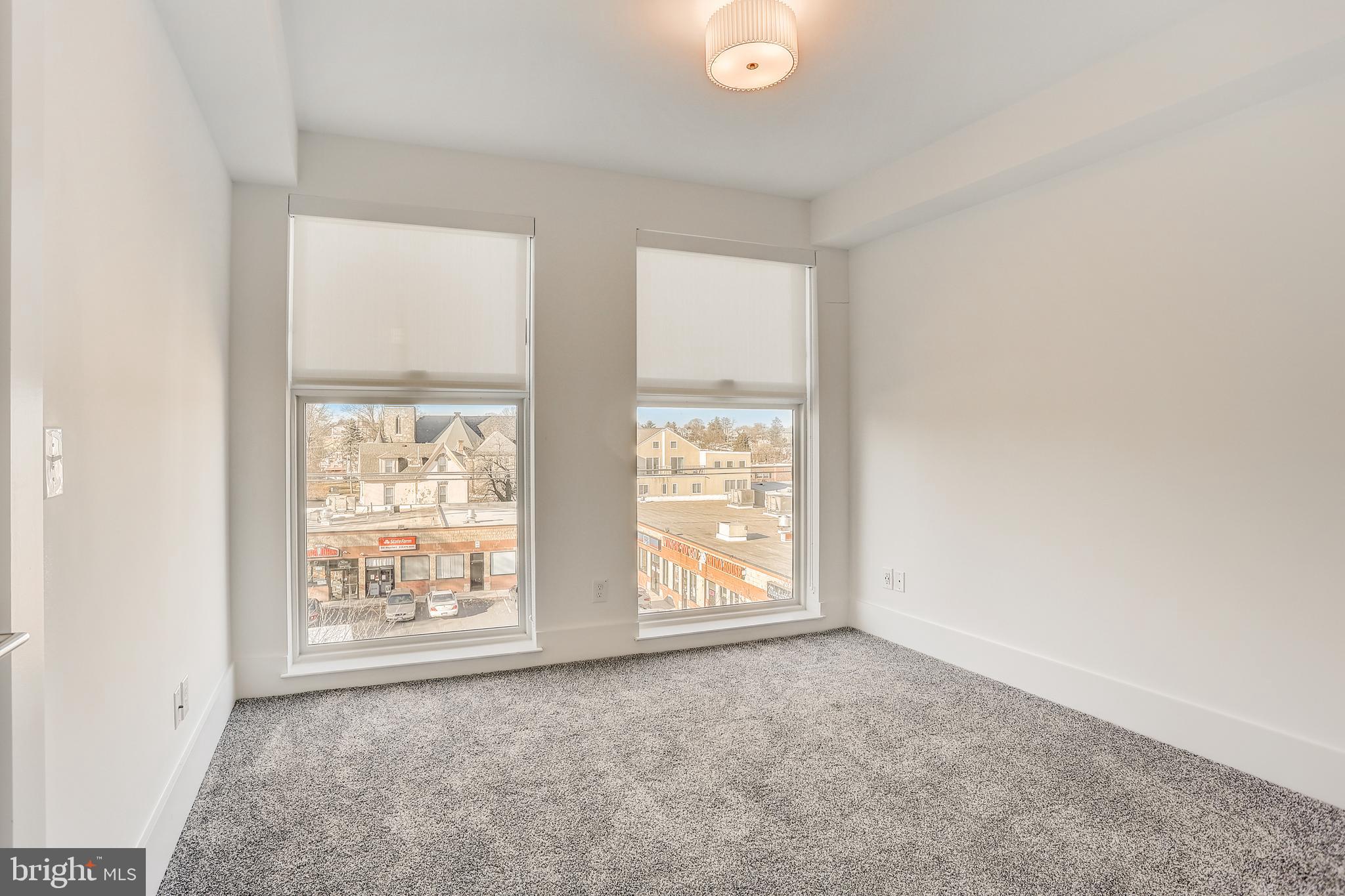 5959-63 Ridge Avenue, Unit 1BED/1BATH Philadelphia, PA 19128 - Photo 5 of 32 an empty room with windows