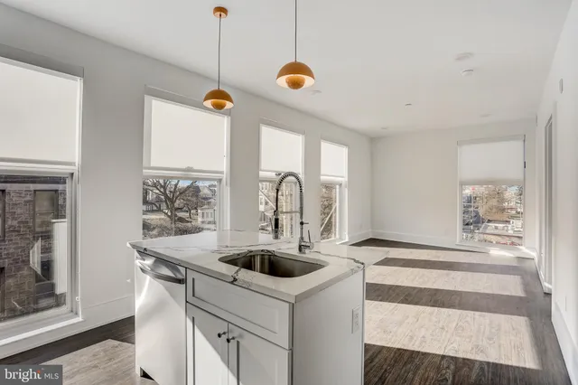 a kitchen that has a sink and a stove